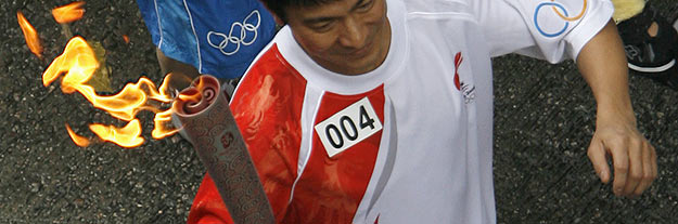 Hong Kong actor Andy Lau carries torch during Beijing Olympic torch relay in Hong Kong